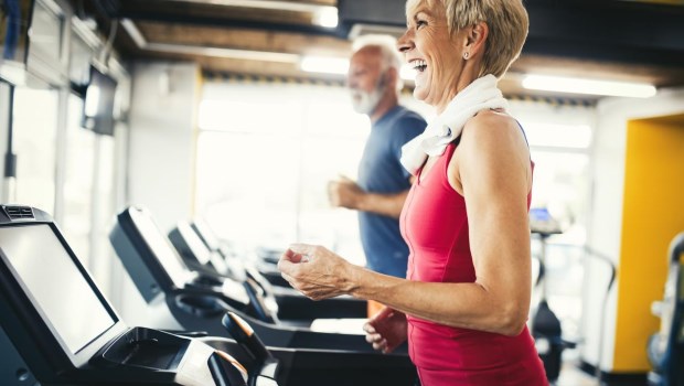 Senior people running in machine treadmill at fitness gym club�