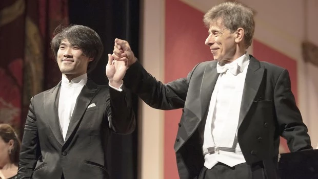 El solista Bruce Liu, debutante en nuestro medio, y el director Latham-Koenig, unidos ante los aplausos finales.­