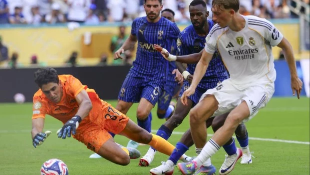 El portero Yassine Bounou del Al Hilal (i) en acción contra Dean Huijsen del Real Madrid (d) durante el partido de fútbol de la Copa Mundial de Clubes
