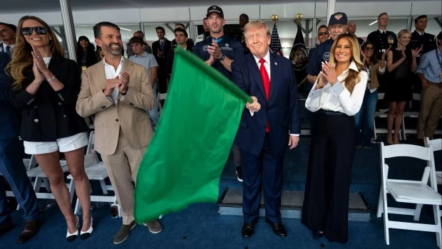 Donald Trump ondea la bandera verde para dar inicio a la carrera de autos IndyCar Freedom 250 Grand Prix, junto a la primera dama Melania.